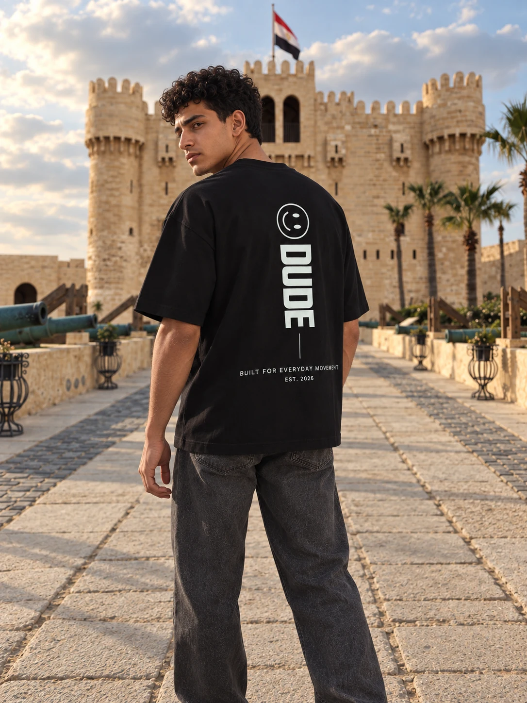 Rear three-quarter view of the black DUDE T-shirt