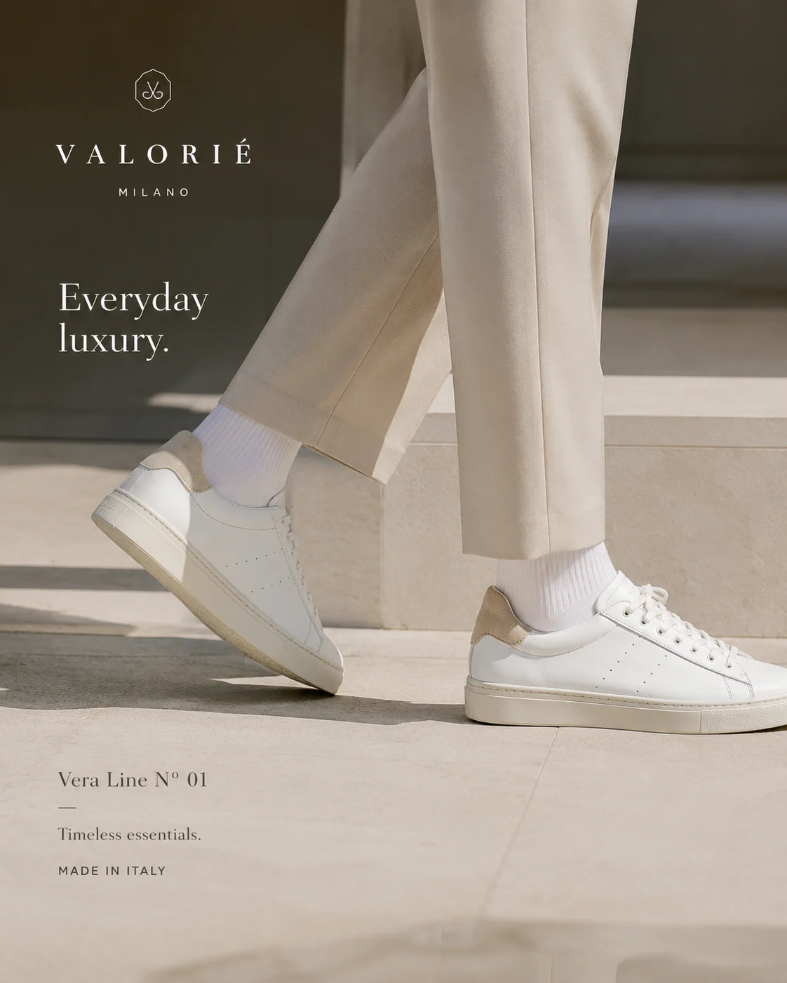 Valorie white leather sneaker on warm pale stone with controlled daylight