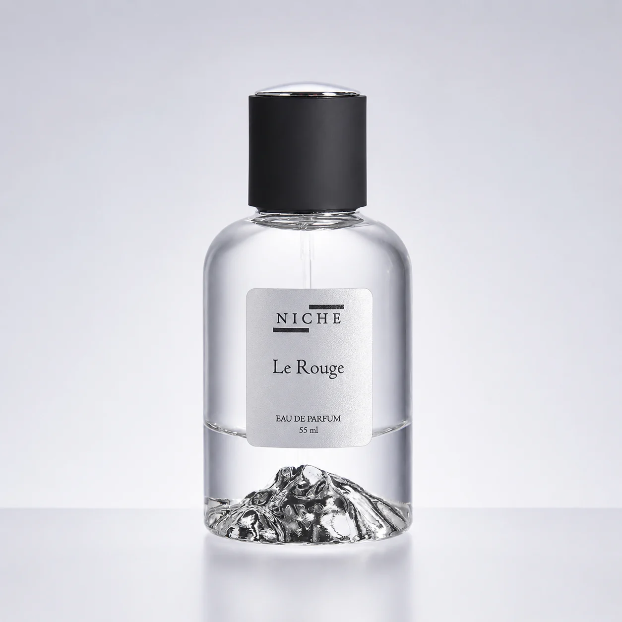 Le Rouge by Niche perfume bottle on a clean pale studio background