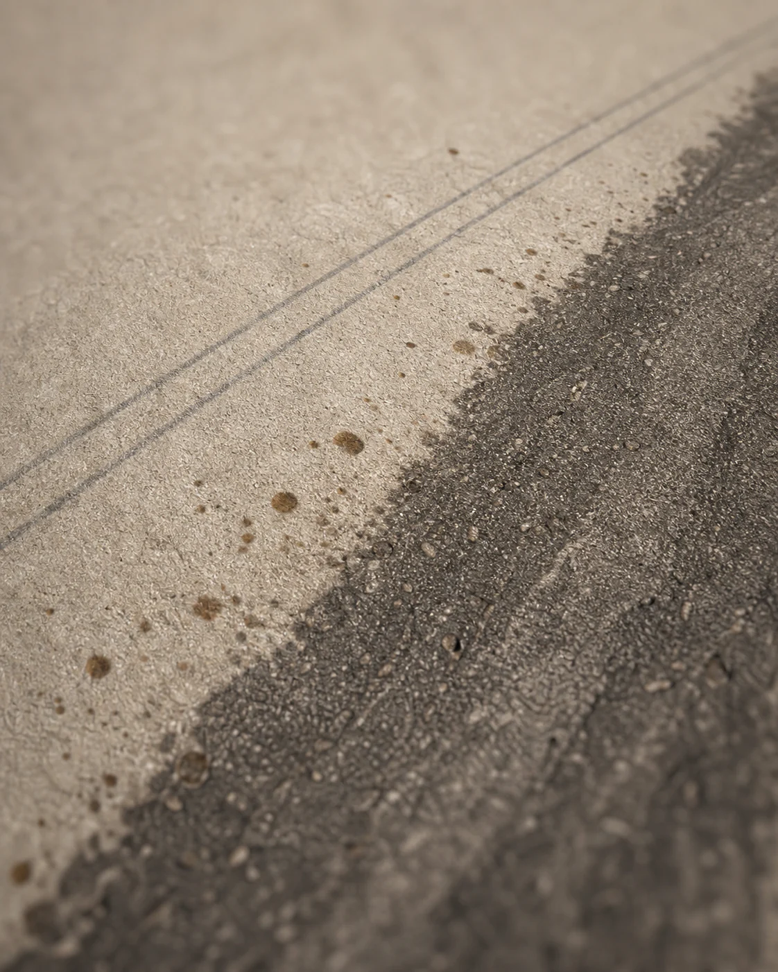 Close view of the honed mineral texture and charcoal-taupe stratum on OROSA Strata 04