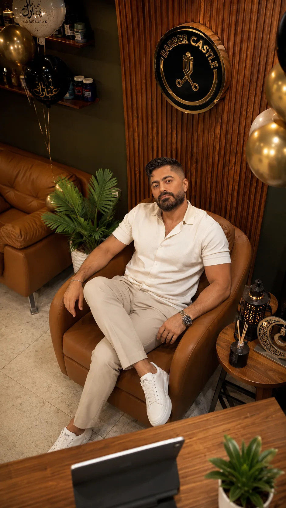 Generated campaign frame of a man seated inside the Eid-decorated Barber Castle salon