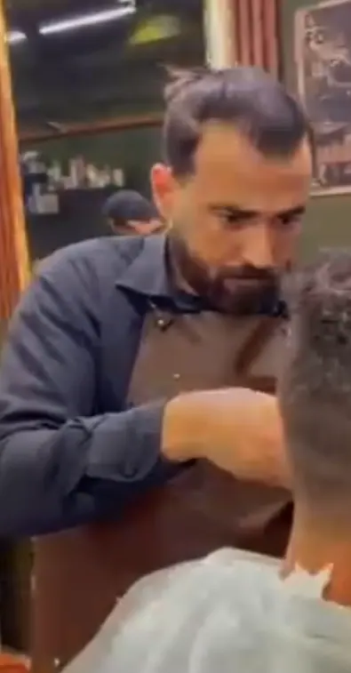 Source video frame of a Barber Castle barber cutting a client's hair