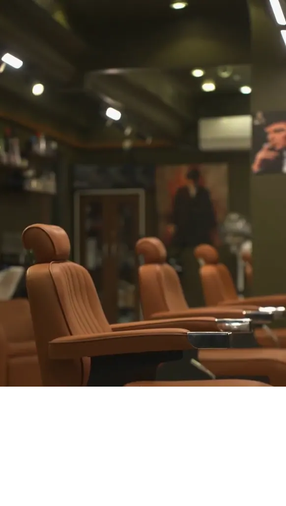 Source reference of empty styling chairs inside Barber Castle