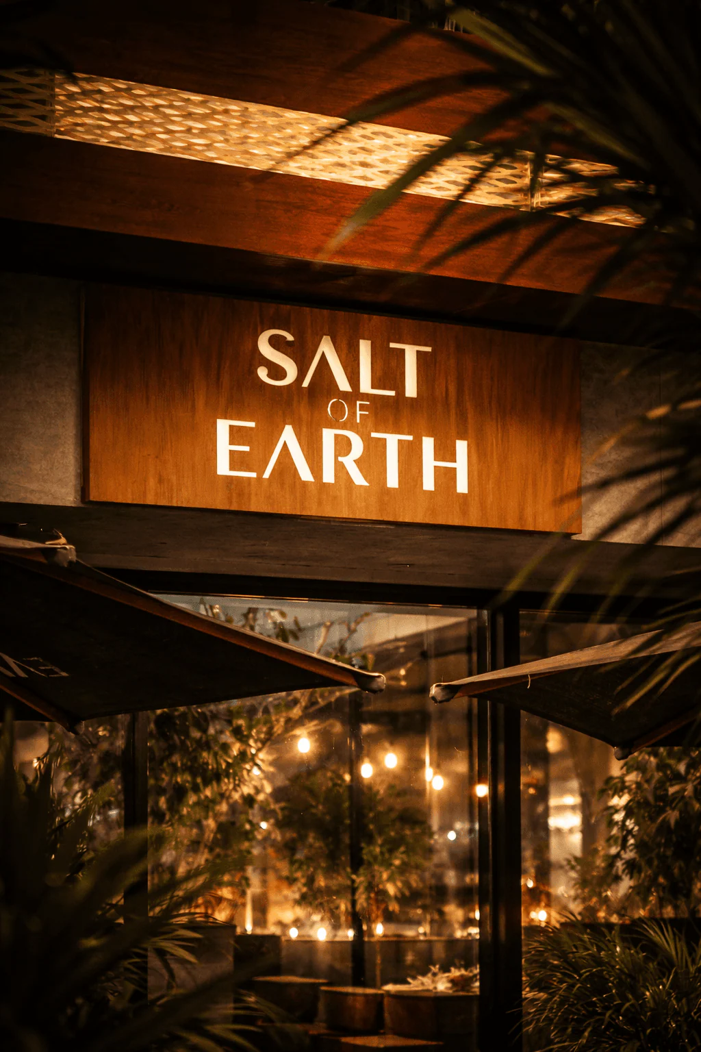 AI-generated cinematic exterior of Salt of Earth restaurant at night