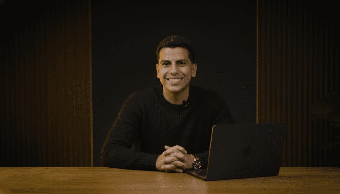 Mohamed Solyman seated at a desk with his laptop